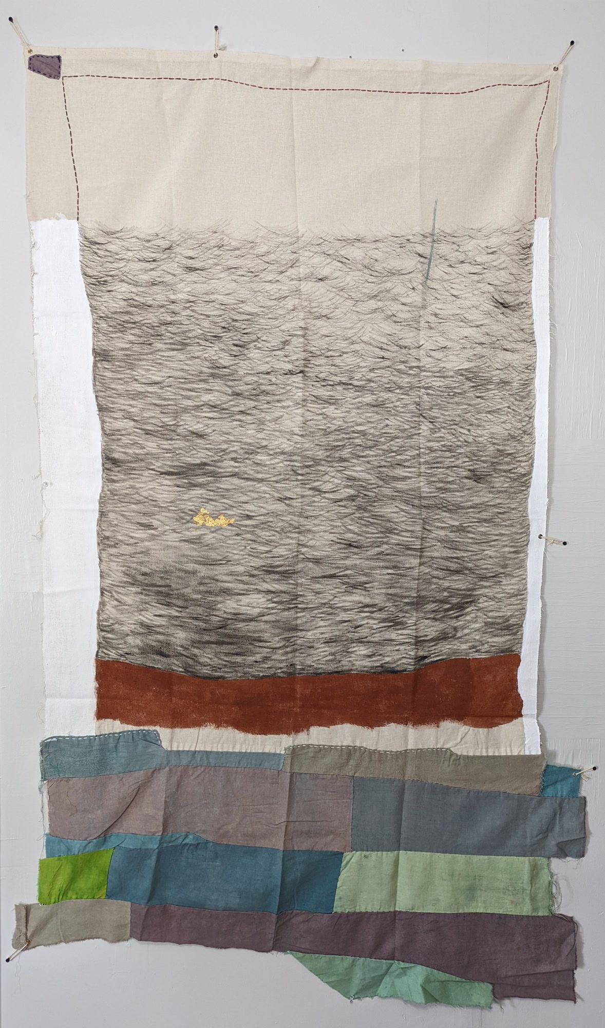 Mixed-media textile painting, Adrift, featuring sweeping washes of warm rust, ochre, and charcoal across draped fabric with delicate accents of gold leaf.