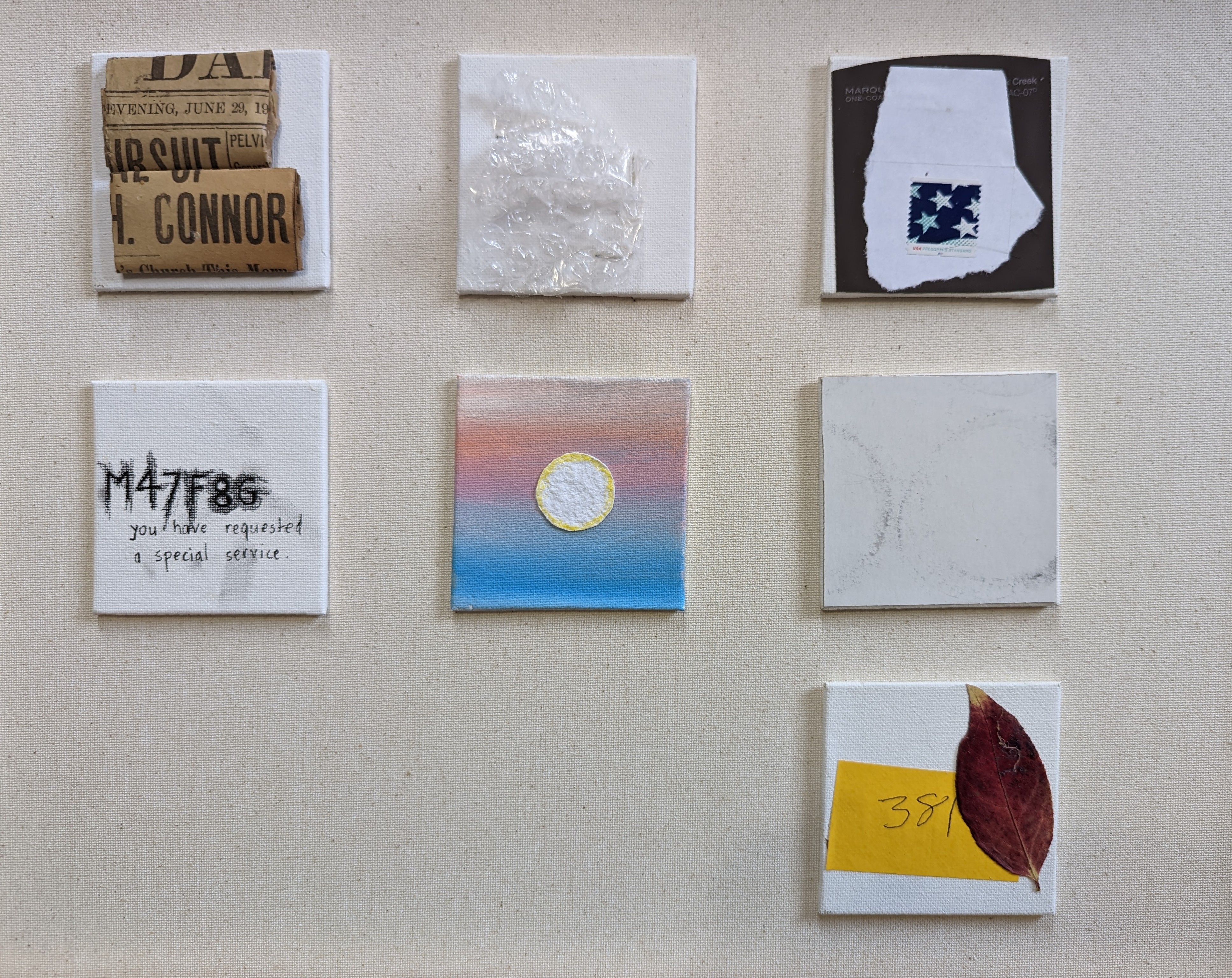 Grid of 7 small assemblages on white canvas and paper on linen: newspaper clippings, crumpled cellophane wrapper, torn white paper envelope with blue star stamp, stenciled text 'M47F86 / you have requested a special service.', painted gradient canvas with circular element, plain white square canvas, and yellow sticky note numbered '381' with a dried leaf.